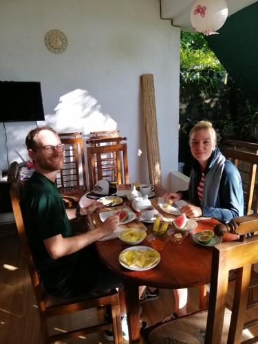 two people sitting at a table eating food at Super View in Ella