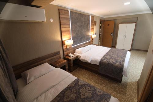 Ένα ή περισσότερα κρεβάτια σε δωμάτιο στο Marbes HOTEL