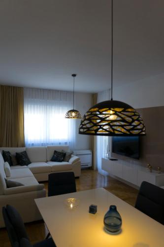 a living room with a couch and a table at Apartman Sunlight in Trebinje