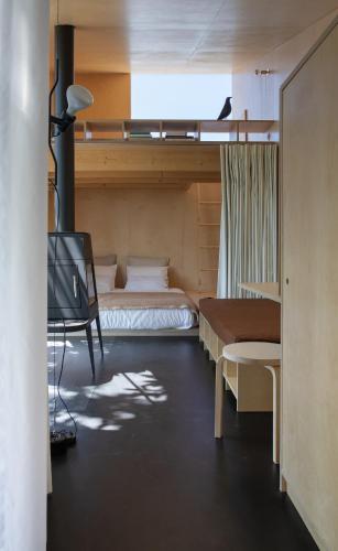 a bedroom with two beds and a tv in it at CASA NO CASTANHEIRO in Meda