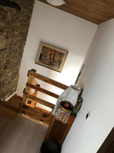 a room with a wooden bed and a painting on the wall at Skalameri in Kozljak