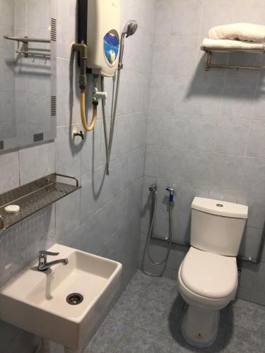 ein Badezimmer mit einem weißen WC und einem Waschbecken in der Unterkunft Fragrance Hotel Johor Bahru in Skudai