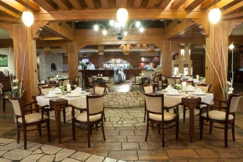 a dining room with tables and chairs in a restaurant at Hotel Szafran in Czeladź