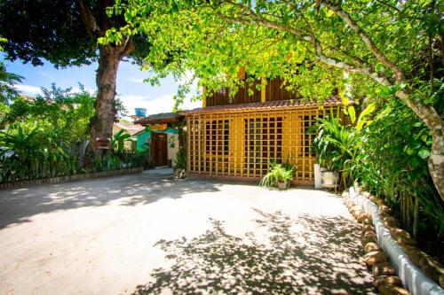 a driveway in front of a house with a fence at Pousada Por do Sol Trancoso in Trancoso