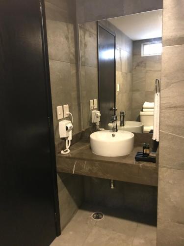 a bathroom with a sink and a mirror at Hotel Costa Verde in Veracruz