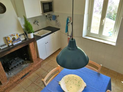 a kitchen with a table and a pot hanging from the ceiling at B&B "Le tre Muse" in Deruta