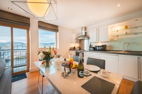 a kitchen with a dining table with a view at Highland Apartments by Mansley in Inverness
