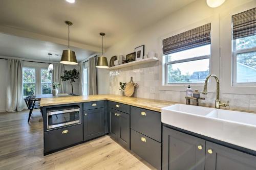 a kitchen with a sink and a counter top at Modern Charm Home Less Than 3 Miles to Magnolia Market! in Waco