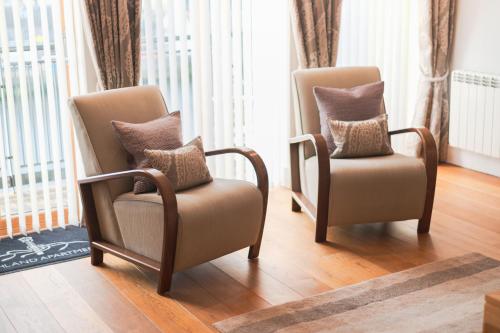 two chairs sitting next to each other in a room at Highland Apartments by Mansley in Inverness