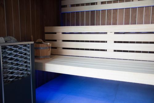 a bed in a room with a wooden wall at Hotel Les Dunes in La Tranche-sur-Mer