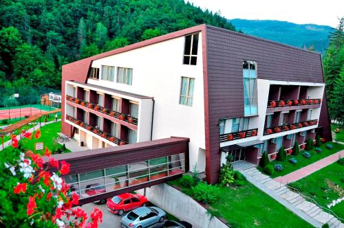 a large building with a large window on top of it at Hotel Clermont in Covasna