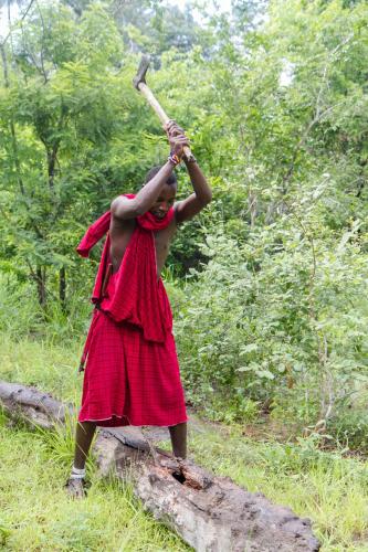 a woman in a red dress holding a stick at Africa Safari Selous Nyerere national park in Nyakisiku