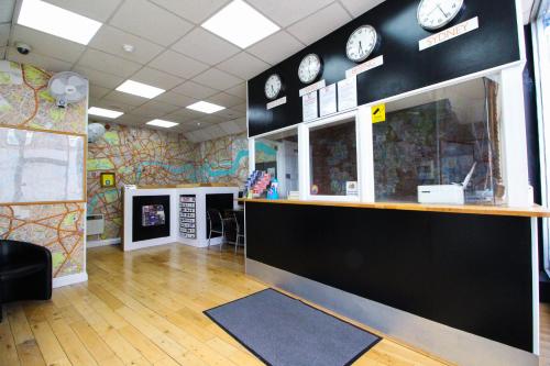 a room with a counter with clocks on the wall at London Backpackers Youth Hostel 18 - 35 Years Old Only in London