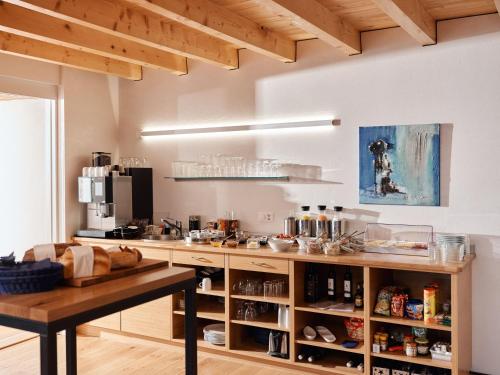 a kitchen with a counter with food on it at Jurabelle in La Côte-aux-Fées