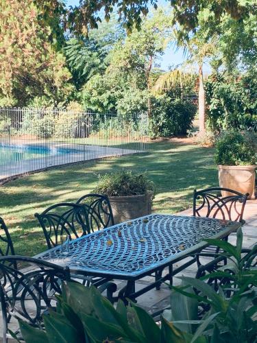 a metal table and chairs sitting on a patio at Happy Lands Farmstay in Addo