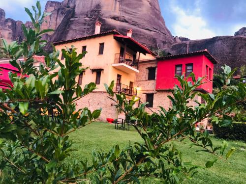 a house with a mountain in the background at Archontiko Mesohori Meteora in Kalabaka