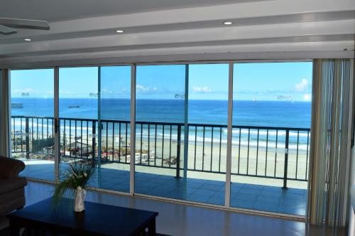 a living room with a view of the ocean at Rosarito Inn in Rosarito