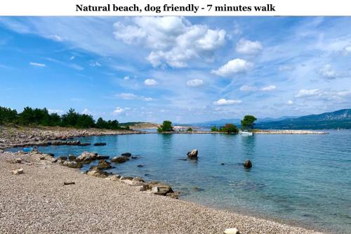 a body of water with some rocks in the water at VSG Resort - Apartments 200m from Beach, Pool, Sauna & Jacuzzi in Klimno