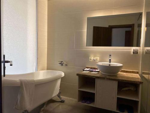 南京的住宿－7天酒店·南京夫子庙御道街店，白色的浴室设有浴缸和水槽。