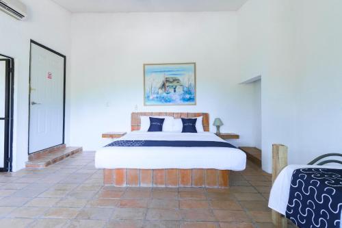 Tempat tidur dalam kamar di Cotlamani Hotel Aventura