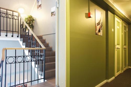 a hallway with stairs and green walls at 16eur - Old Town Munkenhof in Tallinn