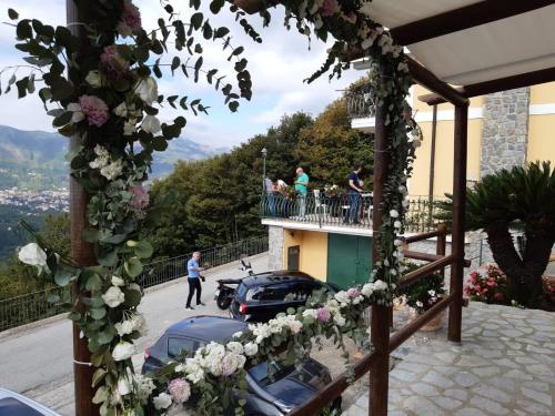 a group of people on the balcony of a building with flowers at B&B Villa Reginella in Agerola