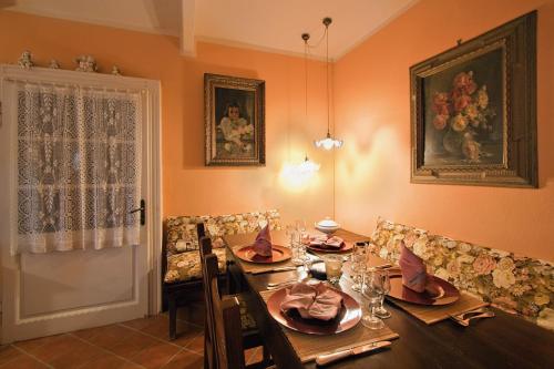 a dining room with a wooden table with chairs and a tableablish at Tenuta Terensano in Monleale