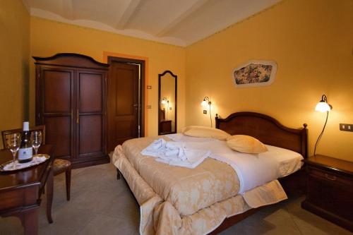 a bedroom with a large bed and a table at Tenuta Terensano in Monleale