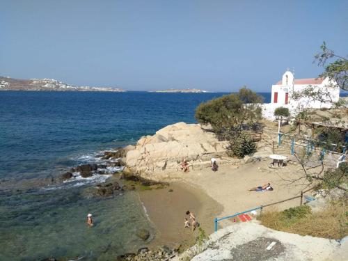 a group of people on a beach near the water at Nikos & Efi Fabrica Residence in Megali Ammos