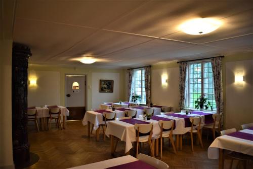TorupにあるTorups Gästgivaregårdのダイニングルーム(テーブル、椅子、紫色のテーブルクロス付)
