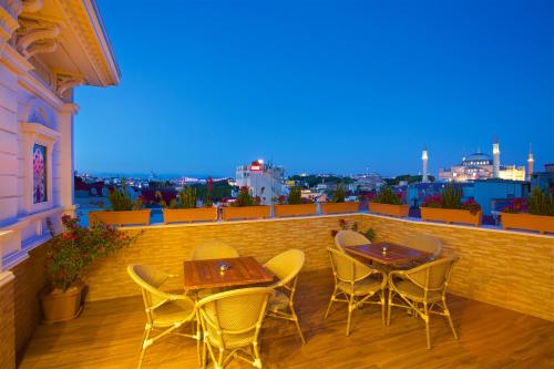 a dining room table with a balcony overlooking a city at White House Hotel Istanbul in Istanbul
