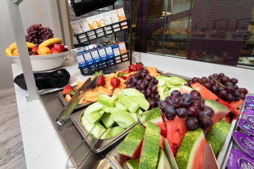 a buffet filled with fruits and vegetables on a counter at Holiday Inn Arlington at Ballston, an IHG Hotel in Arlington