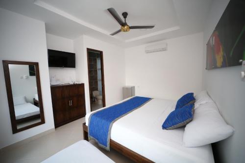 Una cama o camas en una habitación de Hotel Playa Blanca - San Antero
