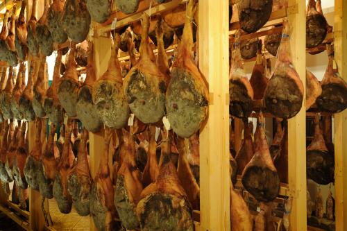 a bunch of cooking utensils hanging on a wall at Belica Bed and Breakfast in Dobrovo
