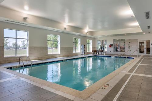 a swimming pool with blue water in a building at Hyatt Place Indianapolis Carmel in Carmel
