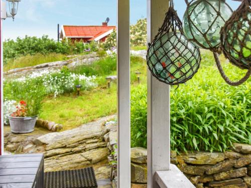 two views of a garden from a porch with a net at 4 person holiday home in R nn ng in Rönnäng