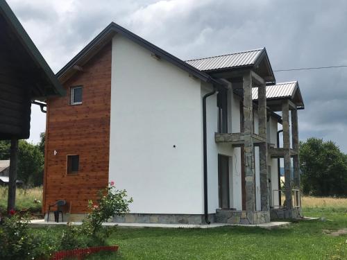 a white house with a brick building at Vila Montenegrina in Kolašin