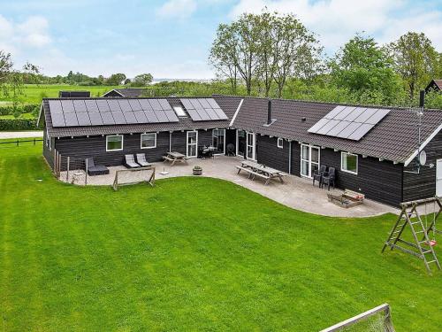 een luchtzicht op een huis met zonnepanelen erop bij 18 person holiday home in Ebeltoft in Ebeltoft