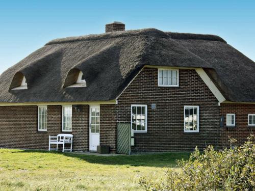 a thatch roofed house with a thatched roof at 9 person holiday home in Harbo re in Harboør