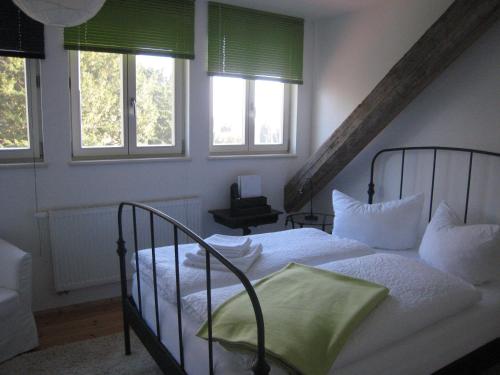 a bedroom with two beds and two windows at To`n Schlagboom in Wangerland