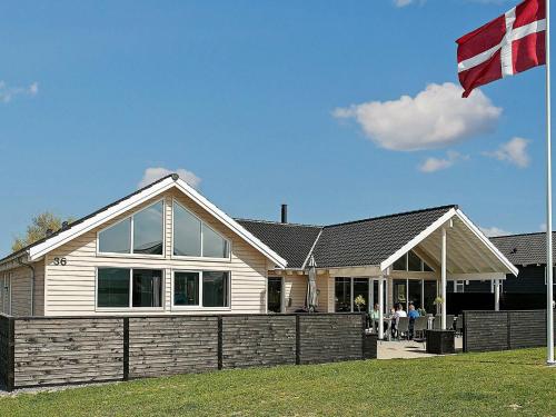 a house with a flag in front of it at 18 person holiday home in Bogense in Bogense