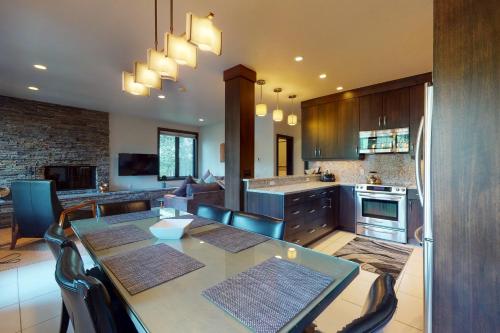 a kitchen with a table and a dining room at Sun Vail 24A in Vail