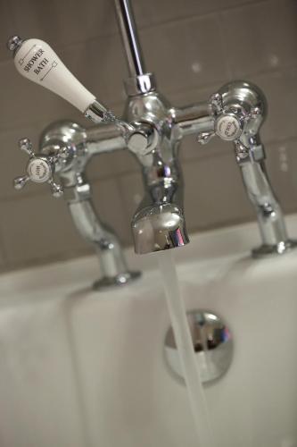 a toothbrush in a holder on a bathroom sink at The Crown And Thistle, Abingdon in Abingdon