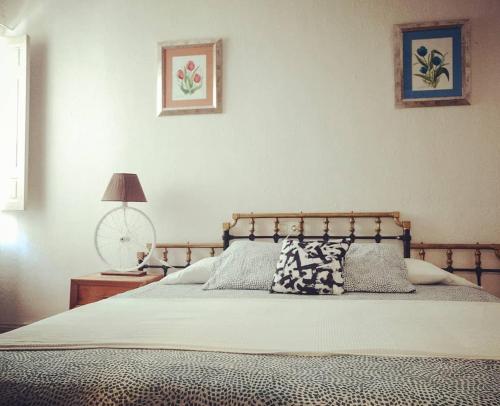 a bedroom with a bed and a table with a lamp at La Casa De Las Bicicletas in Cazorla