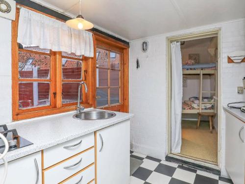 a kitchen with a sink and a window at 4 person holiday home in Ærøskøbing-By Traum in Ærøskøbing