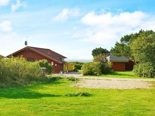 a house in a field next to a dirt road at 7 person holiday home in Vestervig in Vestervig