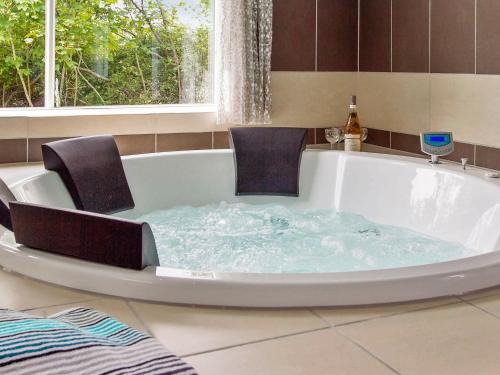 a bath tub with two chairs in it at Holiday home Kappeln IX in Kappeln