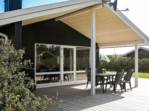 a pavilion with a table and chairs on a deck at 6 person holiday home in Harbo re in Harboør