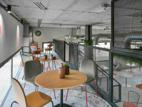a room with tables and chairs on a balcony at Ibis Madrid Getafe in Getafe