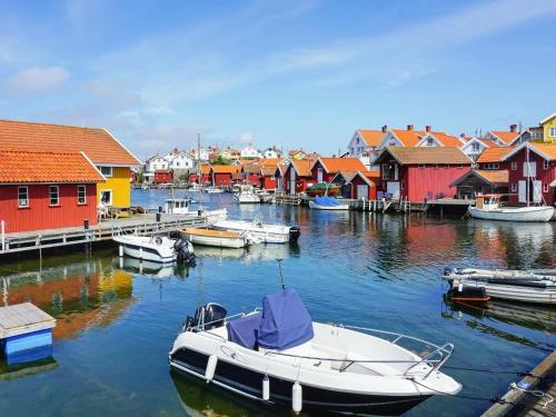 a boat is docked in a harbor with colorful houses at Holiday home Gullholmen in Gullholmen